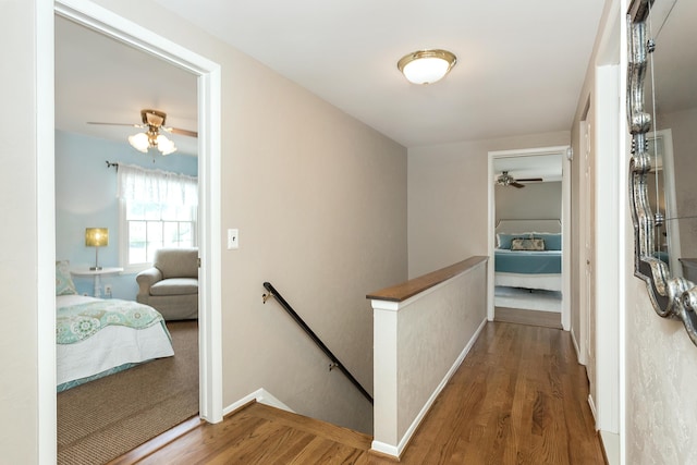 647 S Spinningwheel Ln, Michigan, MI 48304 - hallway with an upstairs landing, wood finished floors, and baseboards