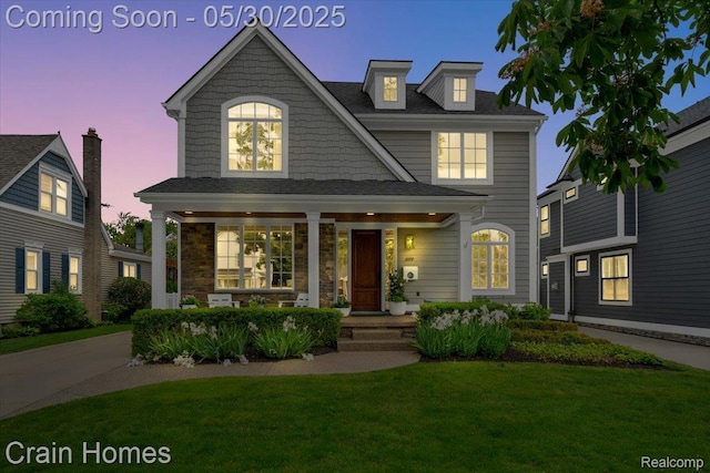499 Catalpa Dr, Birmingham, MI 48009 - view of front facade featuring a front yard, a porch, and stone siding