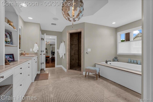 499 Catalpa Dr, Birmingham, MI 48009 - bathroom with vanity, a garden tub, tiled shower, baseboards, and tile patterned flooring