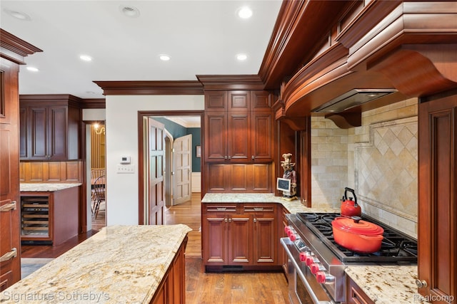 401 Dunston Rd, Bloomfield Hills, MI 48304 - kitchen featuring wood finished floors, tasteful backsplash, cooktop, ornamental molding, and light stone countertops