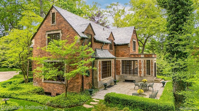 401 Dunston Rd, Bloomfield Hills, MI 48304 - rear view of house featuring a patio area, a high end roof, and brick siding