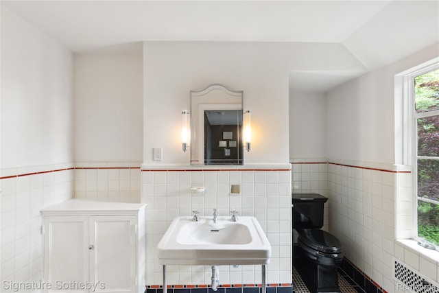 401 Dunston Rd, Bloomfield Hills, MI 48304 - bathroom with tile walls, toilet, a wainscoted wall, a sink, and radiator heating unit