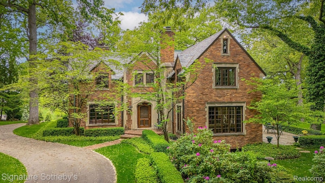 401 Dunston Rd, Bloomfield Hills, MI 48304 - tudor house with a chimney and brick siding