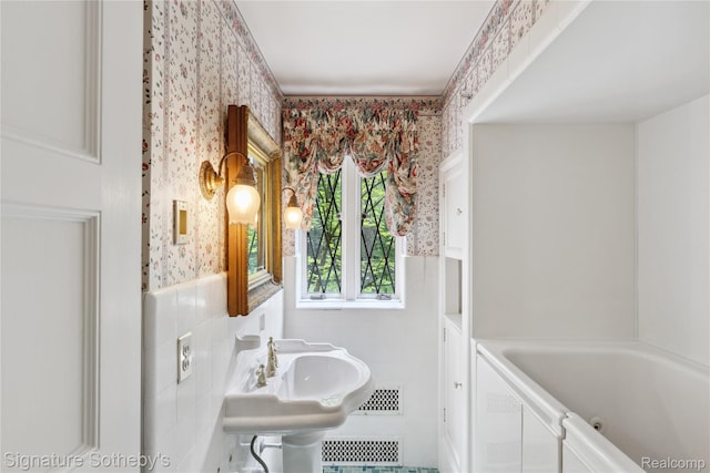 401 Dunston Rd, Bloomfield Hills, MI 48304 - full bath featuring wallpapered walls, a wainscoted wall, a tub with jets, and tile walls