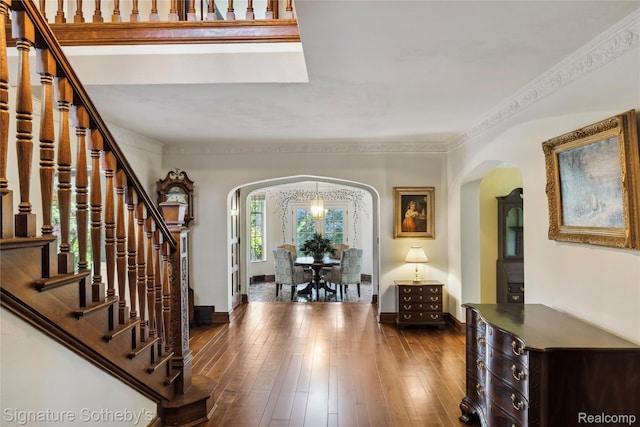 401 Dunston Rd, Bloomfield Hills, MI 48304 - entryway featuring arched walkways, stairs, dark wood-style floors, baseboards, and crown molding