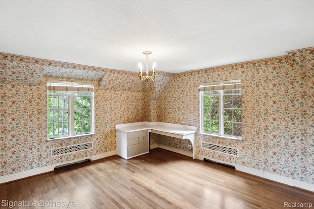 401 Dunston Rd, Bloomfield Hills, MI 48304 - spare room featuring wood finished floors, baseboards, wallpapered walls, a chandelier, and plenty of natural light