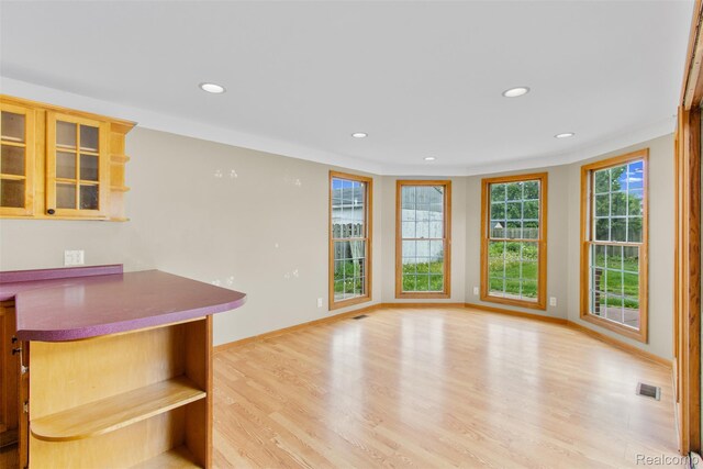 1914 10th St, Port Huron, MI 48060 - kitchen featuring recessed lighting, light wood finished floors, glass insert cabinets, baseboards, and open shelves