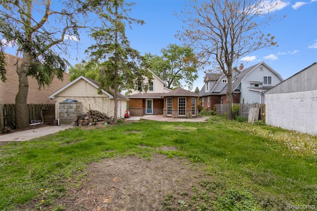 1914 10th St, Port Huron, MI 48060 - rear view of house featuring a patio, an outdoor structure, and brick siding