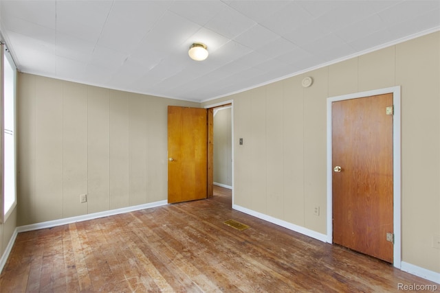 1914 10th St, Port Huron, MI 48060 - unfurnished room with wood finished floors, ornamental molding, a smoke detector, and baseboards