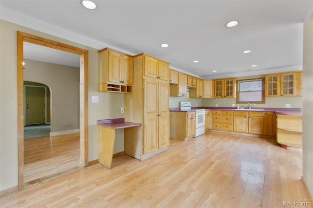 1914 10th St, Port Huron, MI 48060 - kitchen featuring electric stove, a sink, light wood-style flooring, arched walkways, and glass insert cabinets