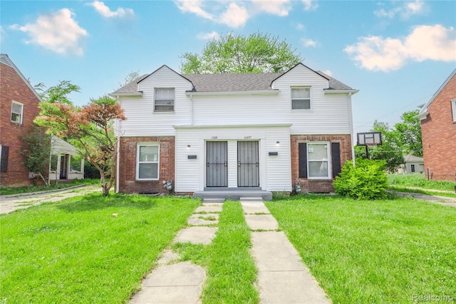 10851 Nottingham Rd, Detroit, MI 48224 - view of property with brick siding, a front lawn, and roof with shingles