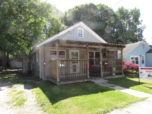 814 Ira Ave, Kalamazoo, MI 49048 - bungalow-style home with a front lawn, board and batten siding, a porch, and an outdoor structure