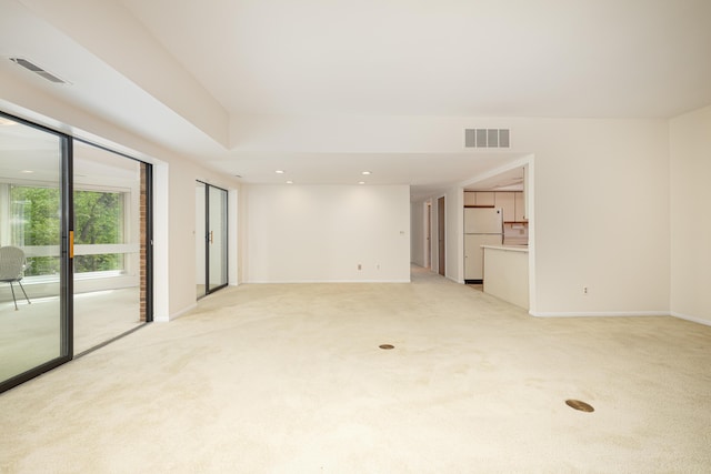 2125208 Nature Cove Ct, Ann Arbor, MI 48104 - unfurnished living room with light colored carpet, baseboards, and recessed lighting
