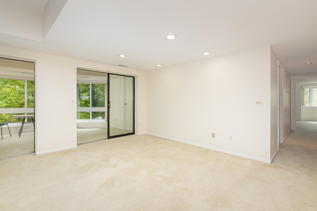 2125208 Nature Cove Ct, Ann Arbor, MI 48104 - unfurnished room featuring light colored carpet, baseboards, and recessed lighting