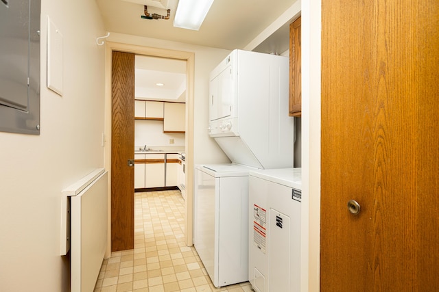 2125208 Nature Cove Ct, Ann Arbor, MI 48104 - laundry area featuring stacked washer / drying machine, light tile patterned floors, and a sink