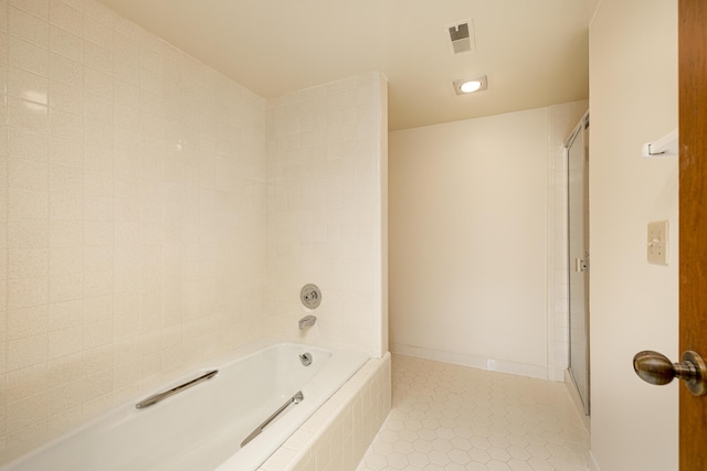 2125208 Nature Cove Ct, Ann Arbor, MI 48104 - bathroom featuring a shower, tile patterned floors, and a relaxing tiled tub