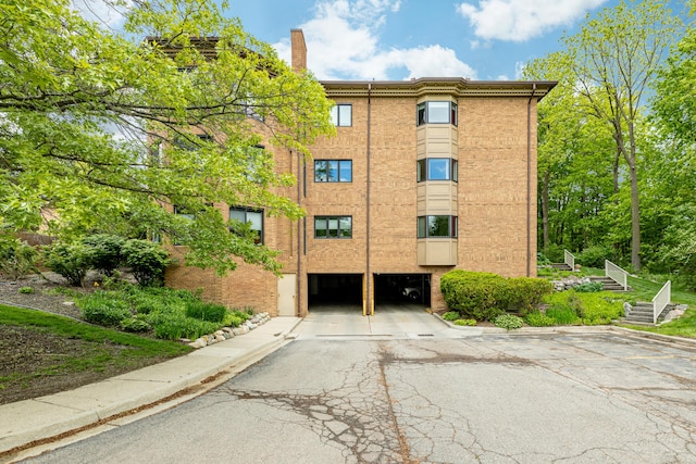 2125208 Nature Cove Ct, Ann Arbor, MI 48104 - view of building exterior featuring a garage and driveway