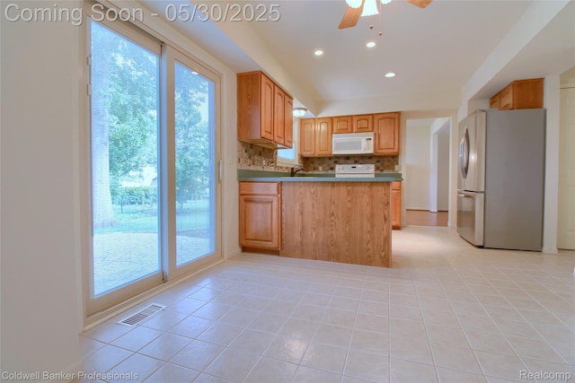 1468 N Morton Taylor Rd, Canton, MI 48187 - kitchen featuring white microwave, freestanding refrigerator, range, ceiling fan, and decorative backsplash