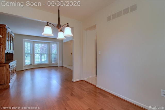1468 N Morton Taylor Rd, Canton, MI 48187 - unfurnished room featuring a chandelier, wood finished floors, and baseboards