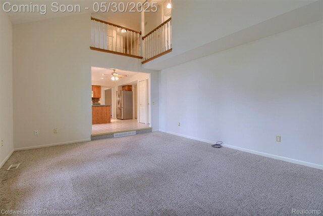 1468 N Morton Taylor Rd, Canton, MI 48187 - unfurnished living room with a high ceiling, baseboards, light colored carpet, and a ceiling fan