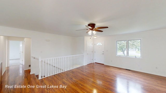 4984 Cactus Dr, Saginaw, MI 48603 - spare room with wood finished floors, a ceiling fan, crown molding, and baseboards
