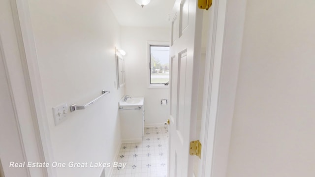 4984 Cactus Dr, Saginaw, MI 48603 - bathroom featuring tile patterned floors, vanity, and baseboards