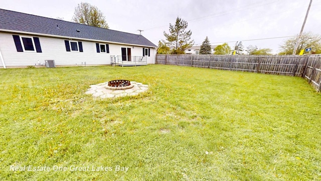 4984 Cactus Dr, Saginaw, MI 48603 - view of yard with a fire pit, a deck, and central air condition unit