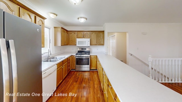 4984 Cactus Dr, Saginaw, MI 48603 - kitchen featuring stainless steel appliances, a sink, light countertops, dark wood-style floors, and ornamental molding