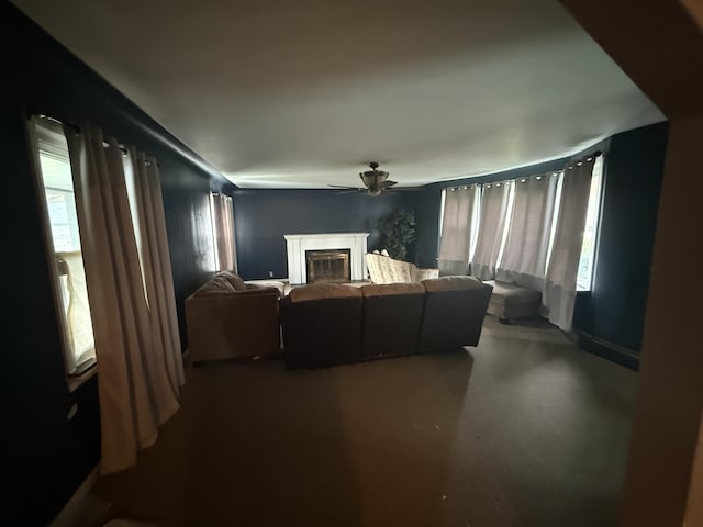 21338 Orchard Lake Rd, Farmington Hills, MI 48336 - living room featuring a glass covered fireplace, ceiling fan, and finished concrete floors