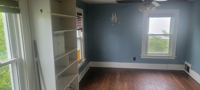 907 Russell St, Kalamazoo, MI 49001 - unfurnished bedroom featuring dark wood-type flooring, baseboards, and a ceiling fan
