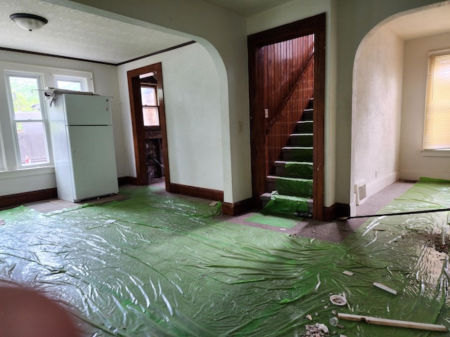907 Russell St, Kalamazoo, MI 49001 - foyer featuring arched walkways, baseboards, and stairs