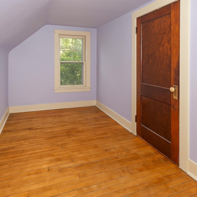 566 Davis St, Ypsilanti, MI 48198 - additional living space with light wood finished floors, vaulted ceiling, and baseboards