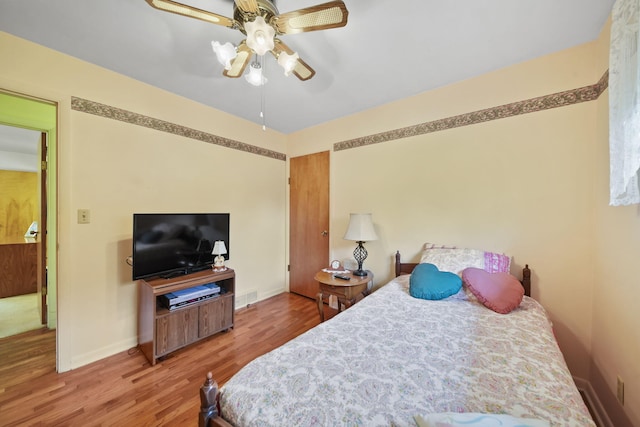 2074 Campbell Dr, Jackson, MI 49202 - bedroom featuring wood finished floors, baseboards, and a ceiling fan