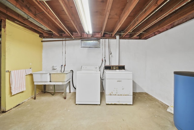 2074 Campbell Dr, Jackson, MI 49202 - laundry area featuring separate washer and dryer, water heater, and concrete block wall