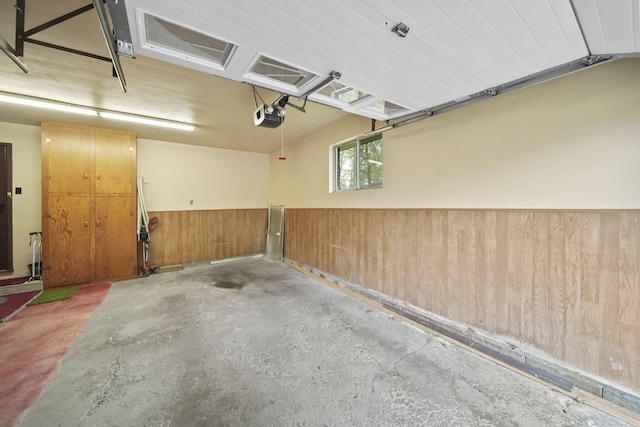 2074 Campbell Dr, Jackson, MI 49202 - garage with a wainscoted wall, wood walls, and a garage door opener