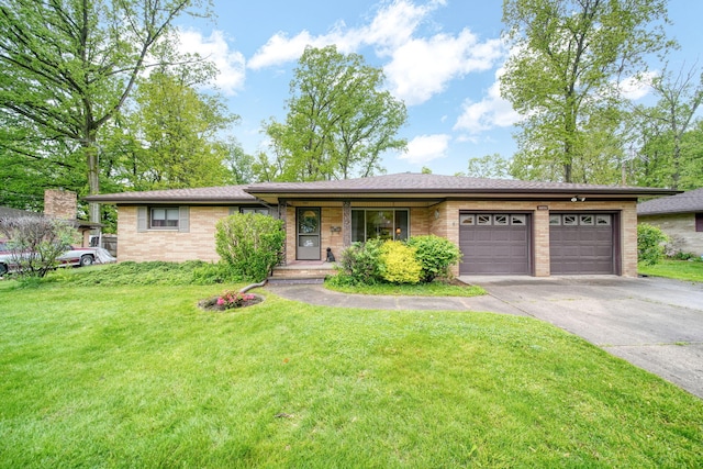 2074 Campbell Dr, Jackson, MI 49202 - single story home with an attached garage, brick siding, concrete driveway, and a front yard