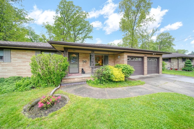 2074 Campbell Dr, Jackson, MI 49202 - view of front facade featuring brick siding, driveway, a porch, and an attached garage