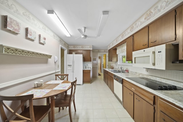 2074 Campbell Dr, Jackson, MI 49202 - kitchen with white appliances, a sink, a ceiling fan, light countertops, and brown cabinets