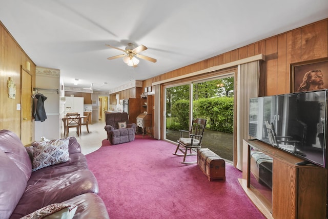 2074 Campbell Dr, Jackson, MI 49202 - carpeted living area featuring wooden walls and a ceiling fan