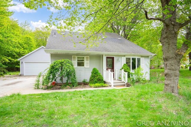 5906 Henry St, Norton Shores, MI 49441 - view of front of property with a front yard, a shingled roof, an attached garage, and driveway