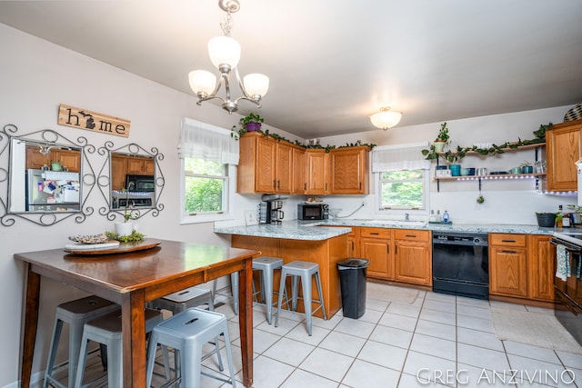 5906 Henry St, Norton Shores, MI 49441 - kitchen featuring black appliances, plenty of natural light, a peninsula, and a chandelier