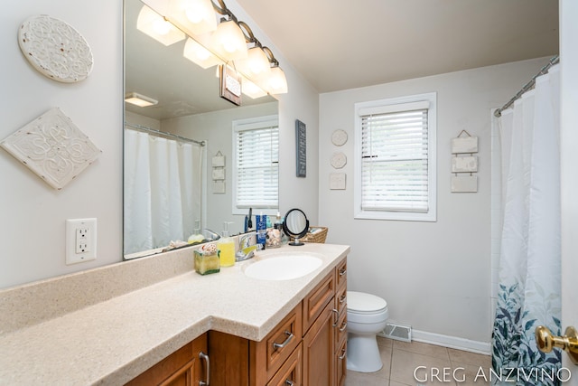 5906 Henry St, Norton Shores, MI 49441 - full bath featuring toilet, vanity, tile patterned floors, baseboards, and curtained shower
