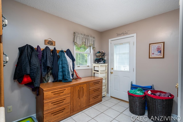 5906 Henry St, Norton Shores, MI 49441 - mudroom with light tile patterned flooring and a textured ceiling