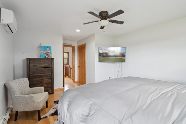 10200 Jerome Rd N, Jerome, MI 49249 - bedroom with light wood-style flooring, a wall mounted air conditioner, baseboard heating, recessed lighting, and a ceiling fan