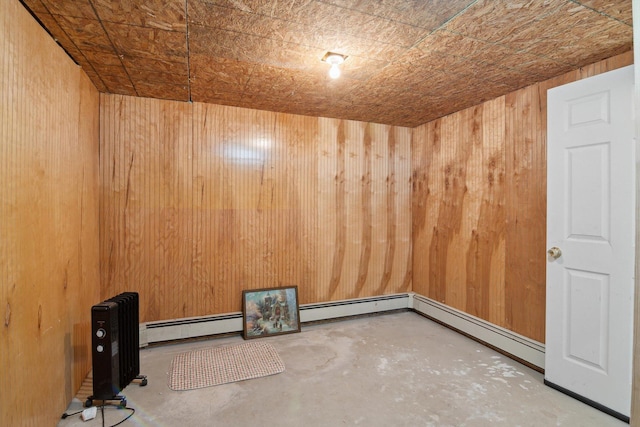 10200 Jerome Rd N, Jerome, MI 49249 - unfurnished room with unfinished concrete flooring, wood walls, and baseboard heating