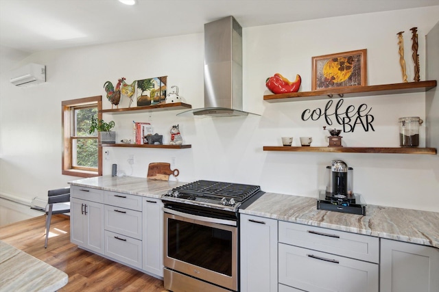 10200 Jerome Rd N, Jerome, MI 49249 - kitchen with open shelves, stainless steel gas range, exhaust hood, a wall mounted AC, and light stone counters