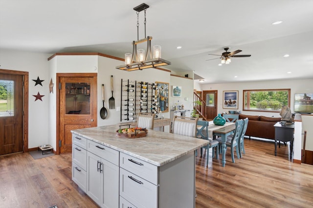 10200 Jerome Rd N, Jerome, MI 49249 - kitchen with open floor plan, a ceiling fan, light wood-type flooring, pendant lighting, and recessed lighting