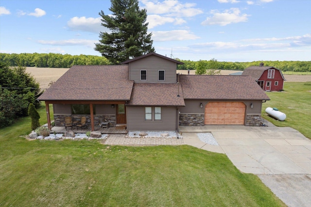 10200 Jerome Rd N, Jerome, MI 49249 - view of front of home with an attached garage, a front yard, concrete driveway, stone siding, and roof with shingles