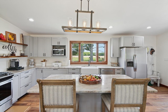 10200 Jerome Rd N, Jerome, MI 49249 - kitchen featuring appliances with stainless steel finishes, a sink, open shelves, light wood-style floors, and gray cabinets
