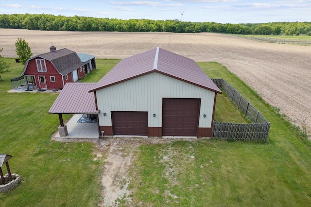 10200 Jerome Rd N, Jerome, MI 49249 - garage with a garage, a rural view, and driveway